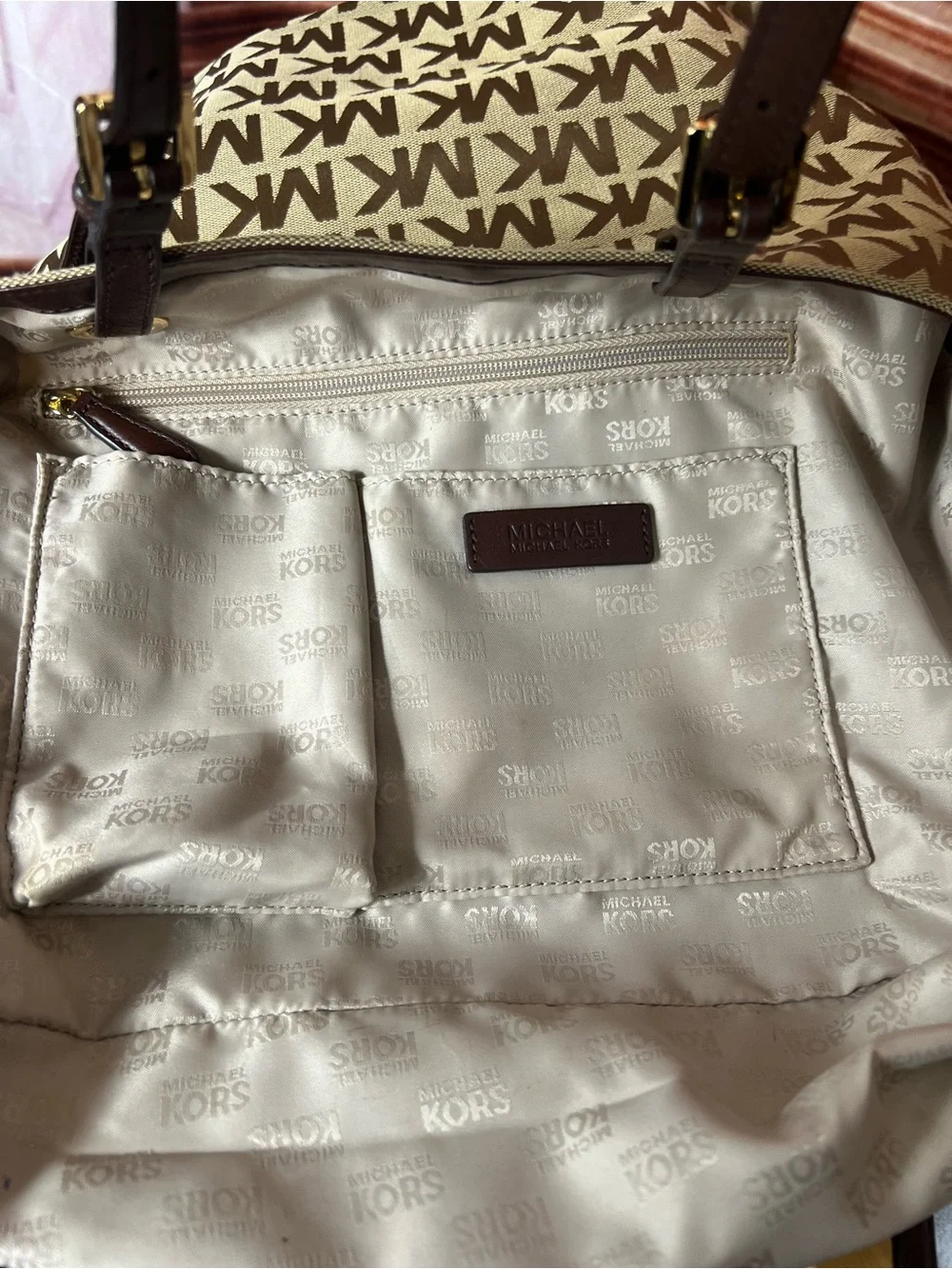 Michael Kors Jet Set tote features monogram canvas, contrasting leather straps